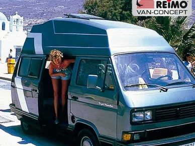 A woman sitting in the back of a van.