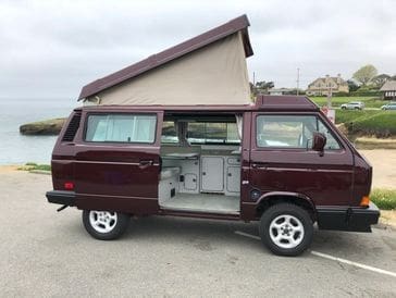 A van with an open door and a roof.