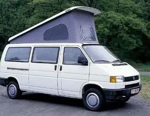 A white van with an open roof on the road.