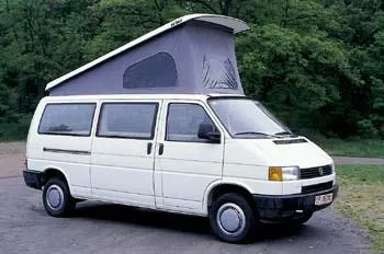 A white van with an open roof on the road.