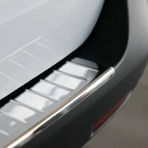 A close up of the bumper and door sill on a car.