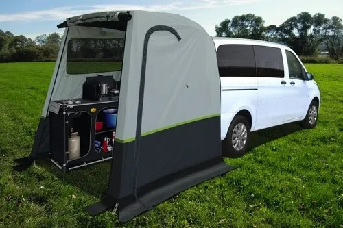 A van with an awning attached to it's back.