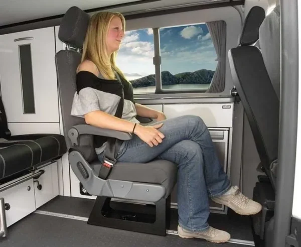 A woman sitting in the back of an rv.